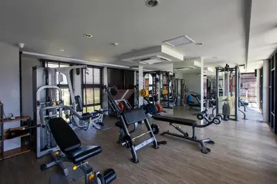 a gym with several treadmills and machines at 6th avenue surin in Surin Beach