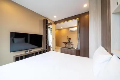 a bedroom with a large bed and a television at Tropical Stay at Apartment B603 in VV Patong in Patong Beach
