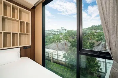 a bedroom with a large window with a view at Tropical Stay at Apartment B603 in VV Patong in Patong Beach