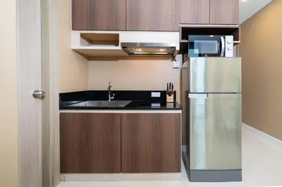 a kitchen with a stainless steel refrigerator and a sink at Tropical Stay at Apartment B603 in VV Patong in Patong Beach