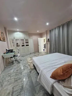 a bedroom with a bed and a desk in it at Superb 3 Bed Pool Villa in Ban Saiyuan (1)