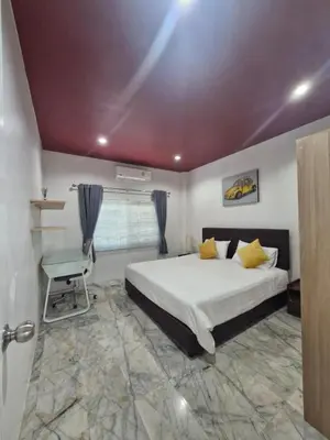a bedroom with a bed and a table and a window at Superb 3 Bed Pool Villa in Ban Saiyuan (1)
