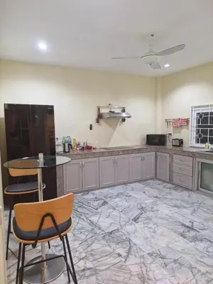 a kitchen with a table and chairs in a room at Superb 3 Bed Pool Villa in Ban Saiyuan (1)