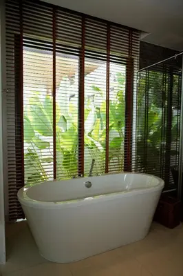 a bath tub in a bathroom with a large window at Villa Altessa 3BR Modern Loft II Botanica in Ban Pak Lak