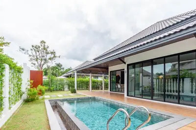 a pool in the backyard of a house at Bangtao Beach Walk Villa by Taan Residence in Bang Tao Beach
