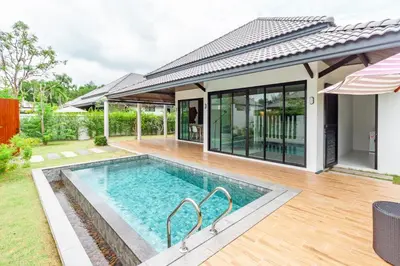 a swimming pool in the backyard of a house at Bangtao Beach Walk Villa by Taan Residence in Bang Tao Beach