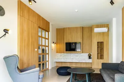 a living room with a couch and a table at Bangtao Beach Walk Villa by Taan Residence in Bang Tao Beach