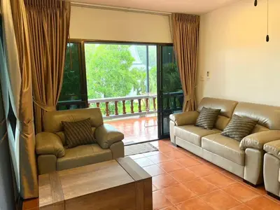 a living room with two couches and a large window at The Vintage Kamala in Kamala Beach
