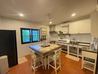 a kitchen with a table and a counter top at The Vintage Kamala in Kamala Beach