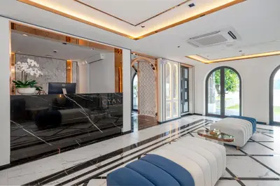 a living room with a couch and a television at The Cyan at Patong Hotel in Patong Beach