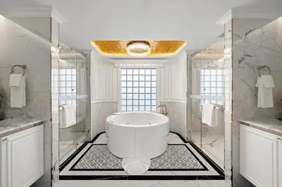 a bathroom with a large tub in the middle at The Cyan at Patong Hotel in Patong Beach