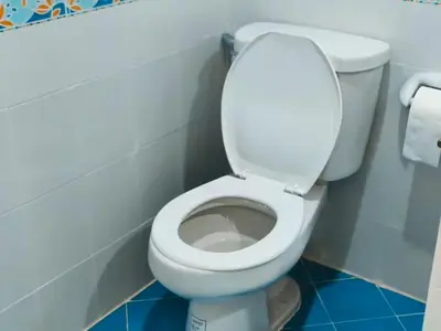 a bathroom with a white toilet in a stall at Central House Phuket in Phuket Town