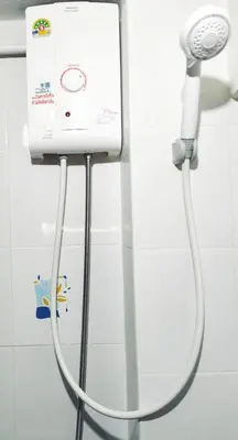 a blow dryer is attached to a wall in a bathroom at Central House Phuket in Phuket Town