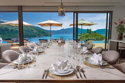 a long table with glasses and napkins on it at Villa Narissa in Kamala Beach