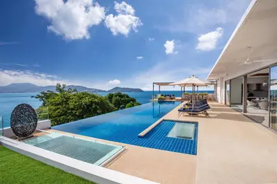 an infinity pool in a villa with a view of the ocean at Villa Narissa in Kamala Beach
