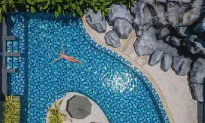 a model of a swimming pool with a red fish in it at Utopia Phuket Naiharn Beach Grand Resort & Spa in Rawai Beach