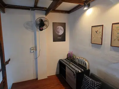 a room with a fan on the wall and a room with at Monkey apartment 6 in Patong Beach