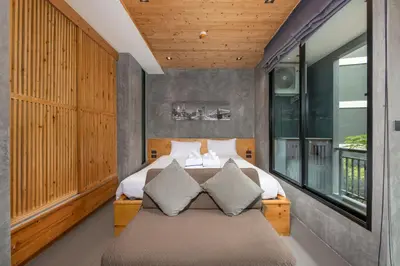 a bedroom with a bed and a large window at Relife Sol 2 min to Nai Harn beach by TropicLook in Rawai Beach