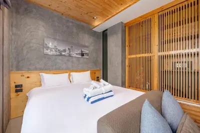 a bedroom with a large white bed and a couch at Relife Zen 2 min to Nai Harn beach in Rawai Beach