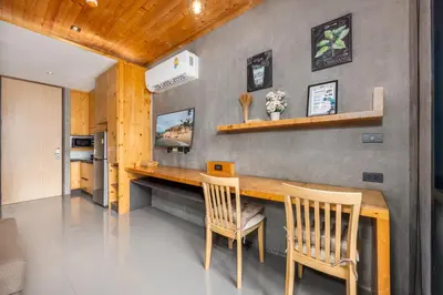 a kitchen with a wooden table and two chairs at Relife Zen 2 min to Nai Harn beach in Rawai Beach