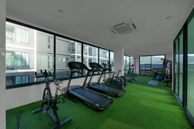 a gym with a row of treadmills and exercise bikes at Relife Zen 2 min to Nai Harn beach in Rawai Beach