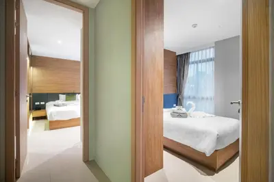 a hotel room with a bed and a mirror at Stylish Beachfront Two-Bedroom Flat in Nai Thon Beach
