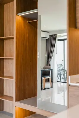 a room with a desk and a chair in a room at Stylish Beachfront Two-Bedroom Flat in Nai Thon Beach