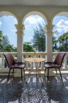 a patio with a table and two chairs at Seaside Patong House - Newly Open in Patong Beach
