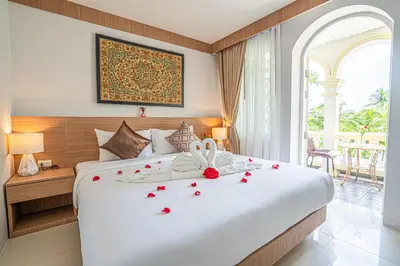 a bedroom with a bed with roses on it at Seaside Patong House - Newly Open in Patong Beach