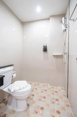 a white bathroom with a toilet and a shower at Seaside Patong House - Newly Open in Patong Beach