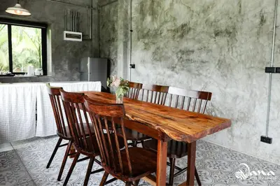 a wooden table and chairs in a kitchen at Nana Villa in Ko Yao Noi