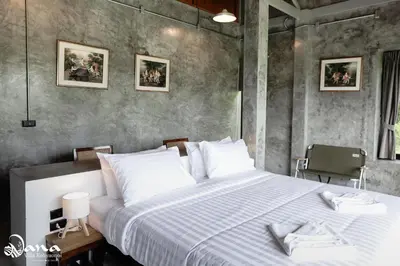 a bedroom with a large bed with white pillows at Nana Villa in Ko Yao Noi