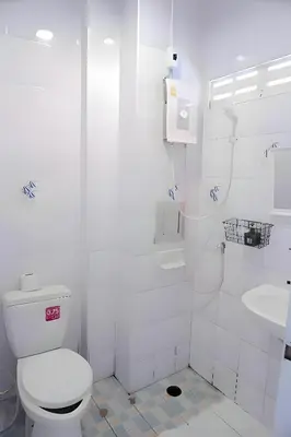 a white bathroom with a toilet and a sink at xx BAO Patong Beach Phuket - เบา ป่าตองบีช in Patong Beach