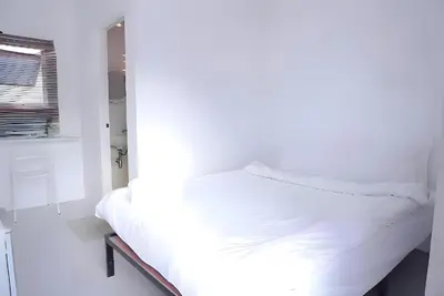 a white bed in a room with a window at xx BAO Patong Beach Phuket - เบา ป่าตองบีช in Patong Beach