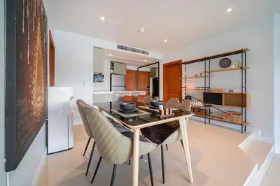 a kitchen and dining room with a table and chairs at Stunning Lake View One Bedroom in Laguna Phuket