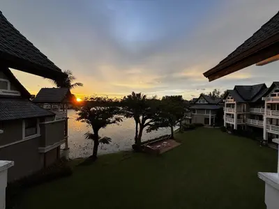 a view of a sunset from an apartment complex at Stunning Lake View One Bedroom in Laguna Phuket