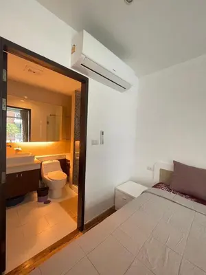 a bathroom with a sink and a toilet and a mirror at Sabai Stay in Patong Beach