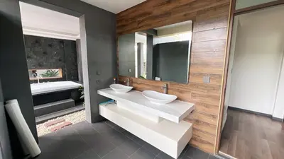 a bathroom with two sinks and a mirror at Ocean home in Laguna Phuket