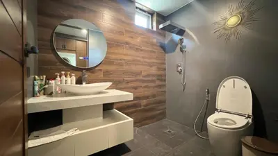 a bathroom with a sink and a mirror and a toilet at Ocean home in Laguna Phuket