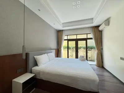 a bedroom with a bed and a large window at Ocean home in Laguna Phuket