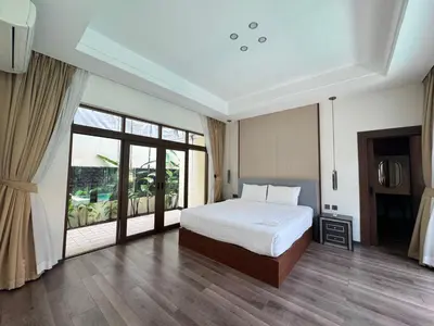 a bedroom with a bed and a large window at Ocean home in Laguna Phuket