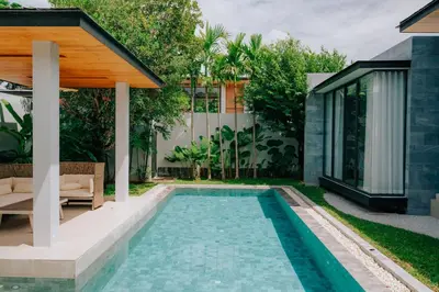 a swimming pool in the backyard of a house at Botanica Foresta Villa in Thalang