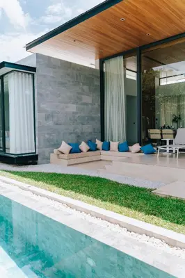 a house with a swimming pool next to a house at Botanica Foresta Villa in Thalang