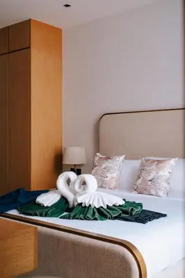 a bed with two swans on top of it at Botanica Foresta Villa in Thalang