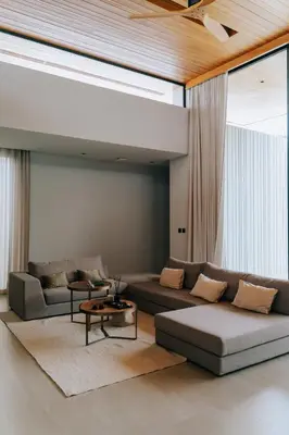 a living room with a couch and a table at Botanica Foresta Villa in Thalang