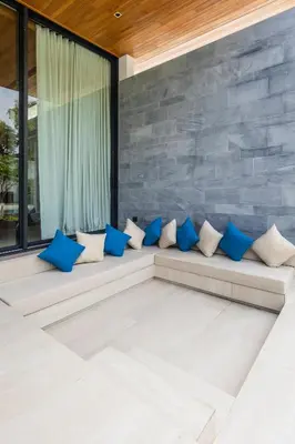a room with blue and white pillows on a couch at Botanica Foresta B10 in Ban Nong Chaeng