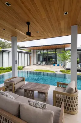 an outdoor living room with a pool and a house at Botanica Foresta B10 in Ban Nong Chaeng