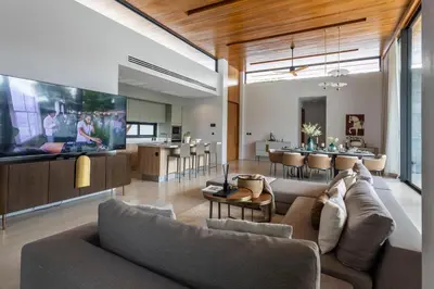 a living room with a couch and a dining room at Botanica Foresta B10 in Ban Nong Chaeng