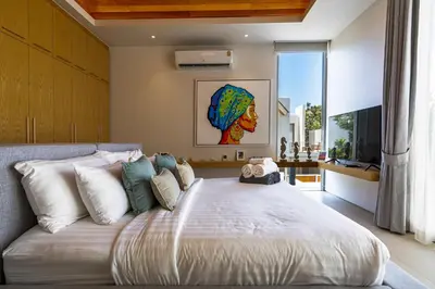 a bedroom with a large bed with white pillows at Luxpride Villa by Wallaya Villas in Ban Thalat Choeng Thale