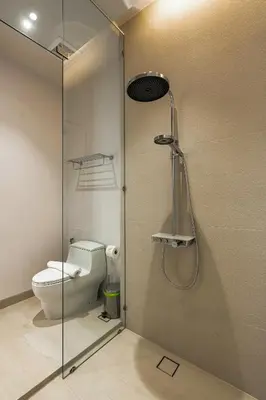 a bathroom with a toilet and a glass shower door at Luxpride Villa by Wallaya Villas in Ban Thalat Choeng Thale